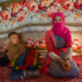 Young adolescent Syrian girl and her brother living in an informal tented settlement in Jordan