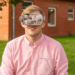 Man wearing virtual reality glasses, pigs reflected in glasses