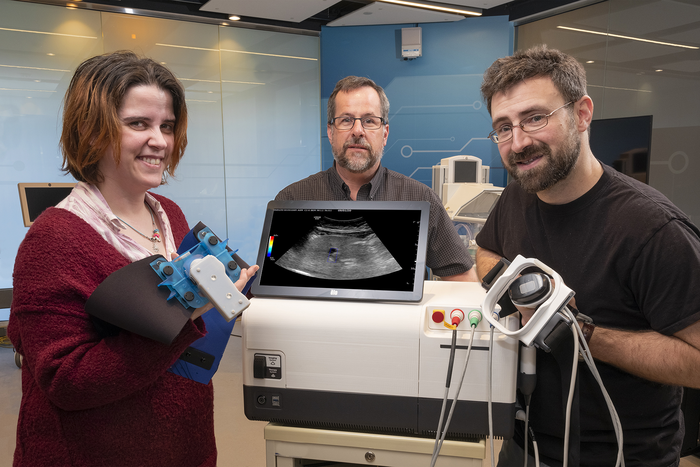 GE Researches Pose With Prototype Ultrasound Modulation Device