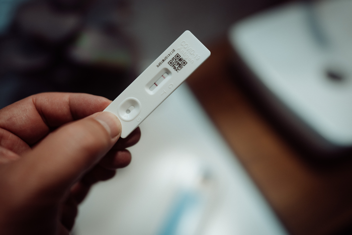 A positive COVID-19 rapid antigen test.