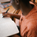 A woman writing in a notebook.