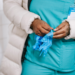 A healthcare worker putting on some gloves.