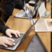 Students on UNLV's campus working on laptops