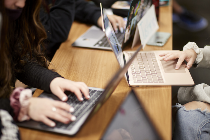 Students on UNLV's campus working on laptops