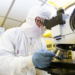 Yuhao Zhang works in a clean room on semiconductor technologies.