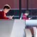 A student looks at his phone in the Student Innovation Center at Iowa State University.