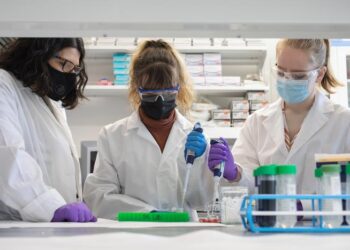 URI Professor Jaime Ross, at left, in her lab