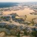 A former mining camp shows where shallow mining ponds have overwhelmed a former river system in the La Pampa region of Madre de Dios, Peru