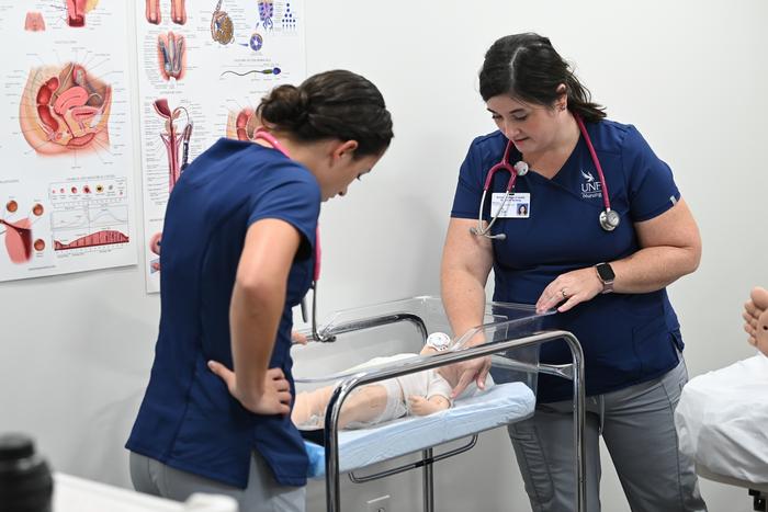 UNF nursing students practice on manikin