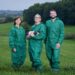 The team (left to right) in hygienic protective clothing with piglets: