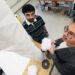 Graduate researcher Vishrut Deshpande and Associate Professor Suyi Li inspect a plant-inspired robot prototype.