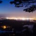 Street lighting creates an artificial glow in the night sky above Plymouth, UK