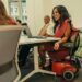 Employees with disabilities meet in a conference room.