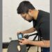 A man takes images of a sweet potato with a camera in a laboratory setting