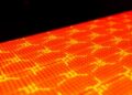 Residue-Controlled Laser Patterning Enables Scalable Fabrication of High-EQE Stretchable OLEDs