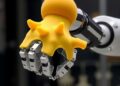 Fin-Ray-inspired soft gripper enables multi-robot manipulation of diverse objects