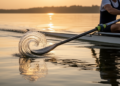 Blade Attachment Boosts Rowing Propulsion by Reshaping Leading-Edge Vortices
